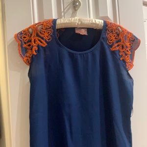 Cute blue and orange tank with orange beaded application on the sleeves.